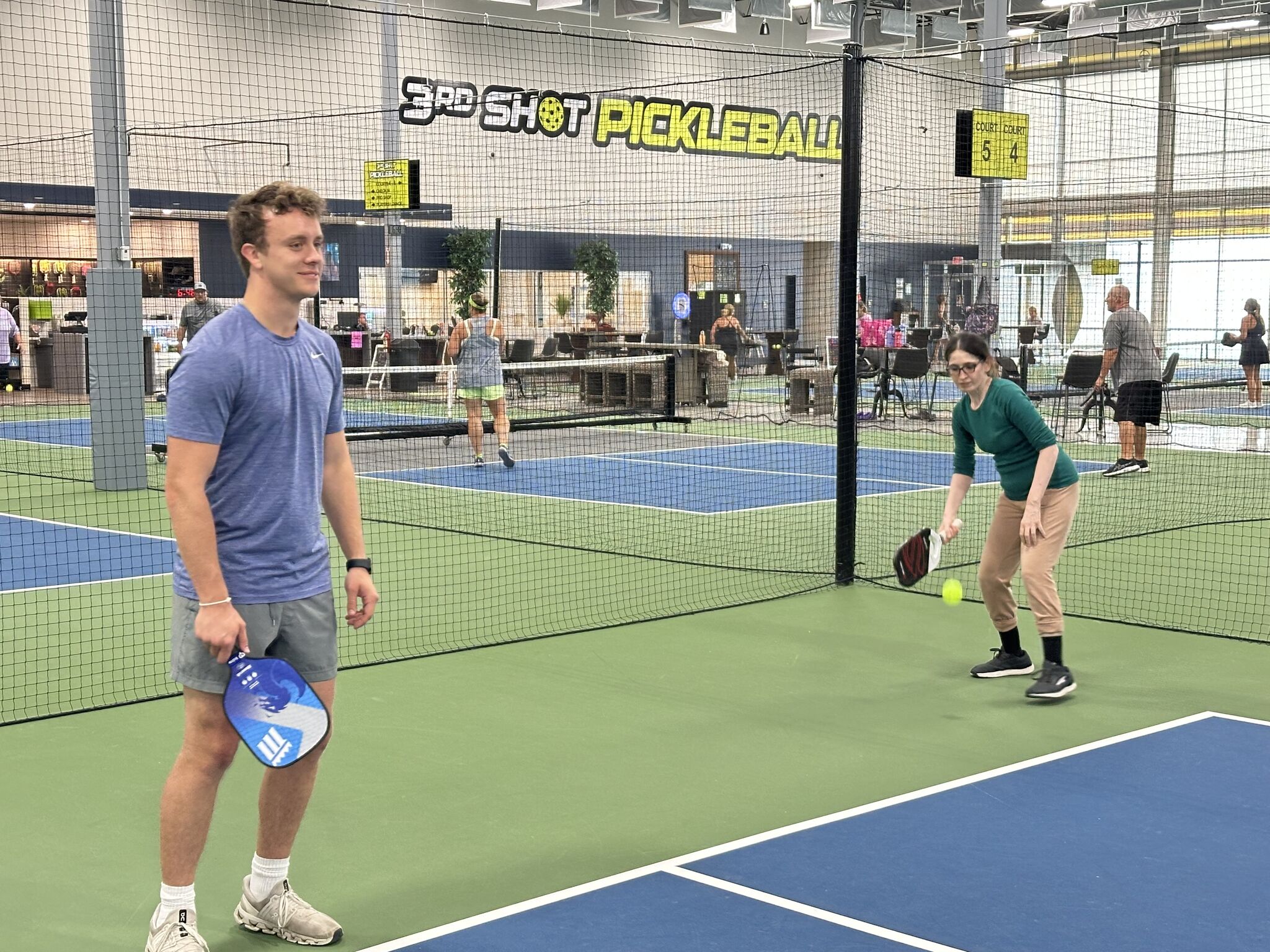 Playing pickleball indoors with a fellow intern at 3rd Shot Pickleball