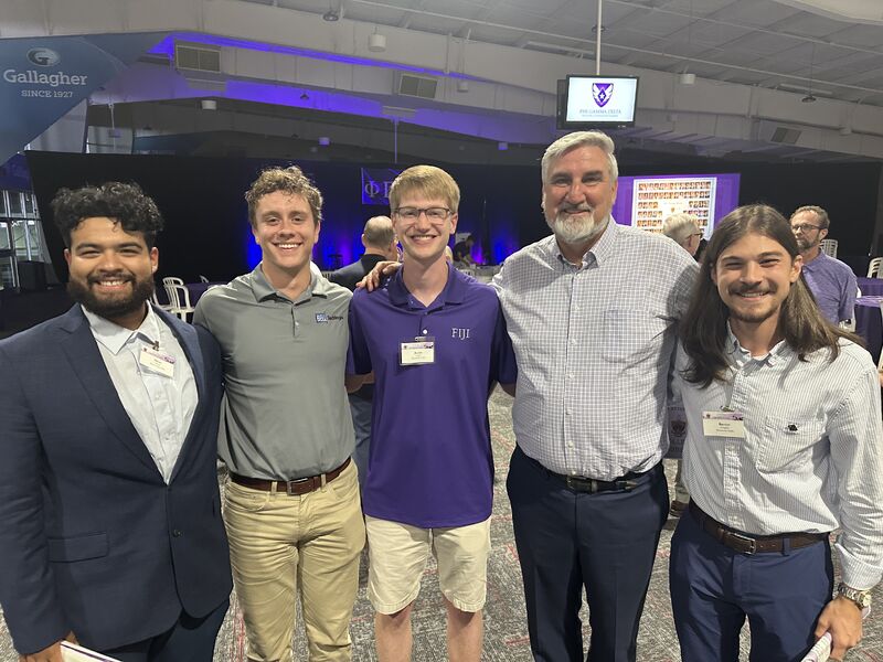 A group of Phi Gamma Delta brothers posing together at the dinner